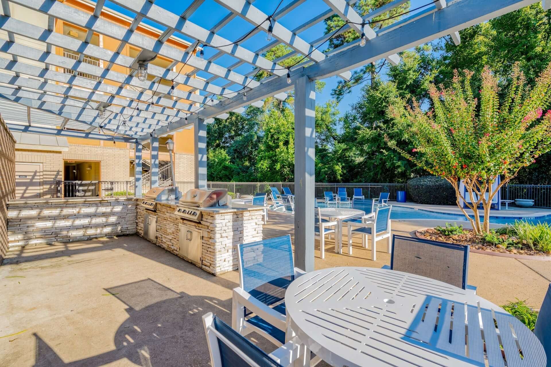 outdoor lounge area by the pool at republic at sam houston apartments